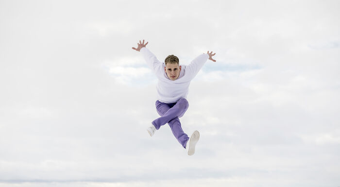 Young man jumping mid-air against cloudy sky, illustrating spooky tales of people passing away and being resurrected.