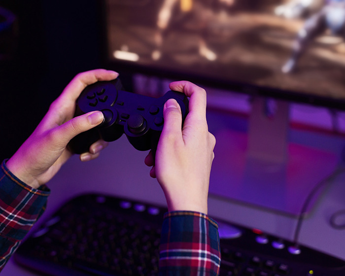 Hands holding a game controller in front of a monitor, illustrating a marriage revelation involving a man and a toddler. Hands holding a game controller in front of a monitor, illustrating a marriage revelation involving a man and a toddler.
