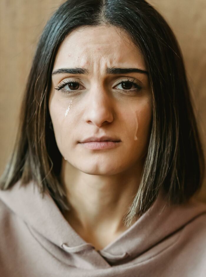 Young woman with tears on her face, appearing distressed, illustrating emotional impact of serotonin syndrome symptoms