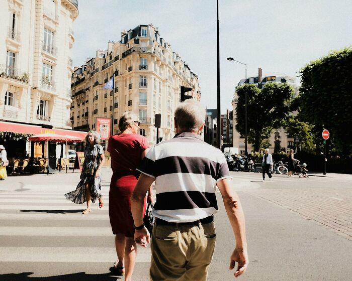 Older adults walking on a sunny city street, representing common boomer opinions and perspectives in urban settings