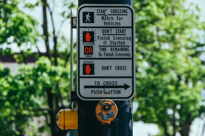 Pedestrian crossing signal with instructions, showcasing an example of real life placebo effect in decision making.
