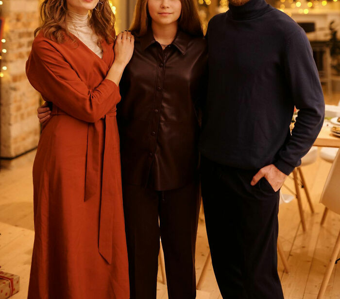 Three young adults standing together indoors, illustrating themes related to middle class challenges and Gen Z perspectives.