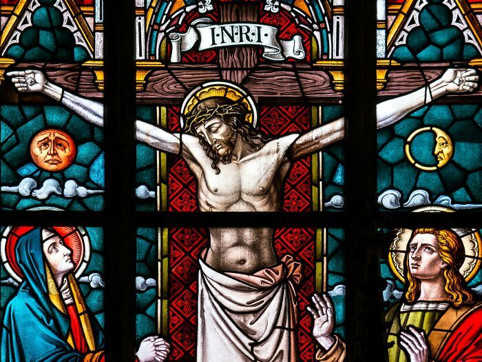 Stained glass window depicting a crucifixion scene, symbolizing surprising discoveries tech guys find fixing computers.