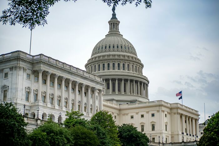 United States Capitol building with flag, representing democracy and historical questions from the 1960s gatekeeping era. United States Capitol building with flag, representing democracy and historical questions from the 1960s gatekeeping era.