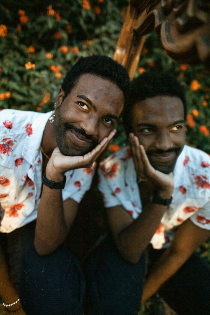 Man with nose ring and floral shirt sitting outdoors, reflecting on moments feeling instantly unsafe with a man.