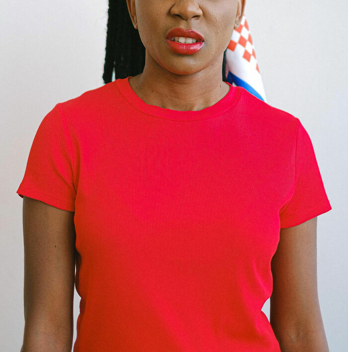 Woman in red shirt showing discomfort and unease reflecting times women felt instantly unsafe with a man.