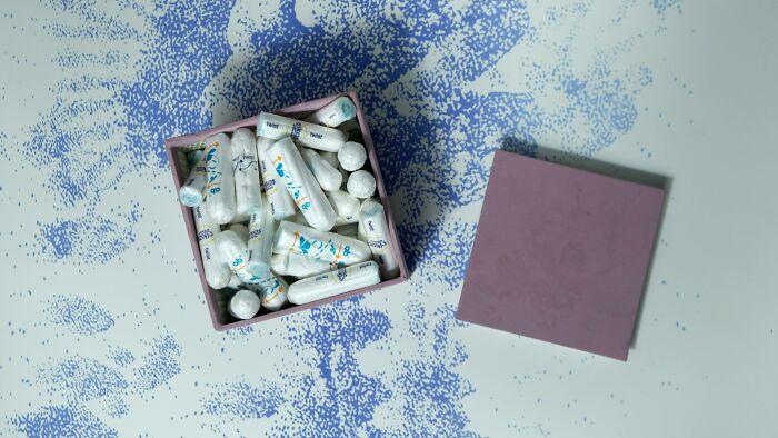 Box filled with mints and scattered blue candy specks representing casual things that can actually be deadly risks.