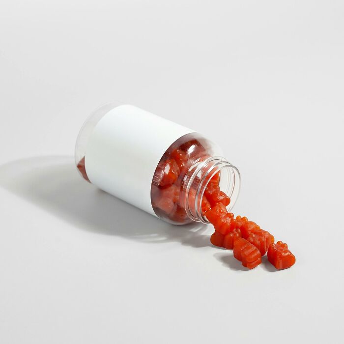 Bottle of red gummy bears spilling out, illustrating examples of placebo effect in real life by netizens.