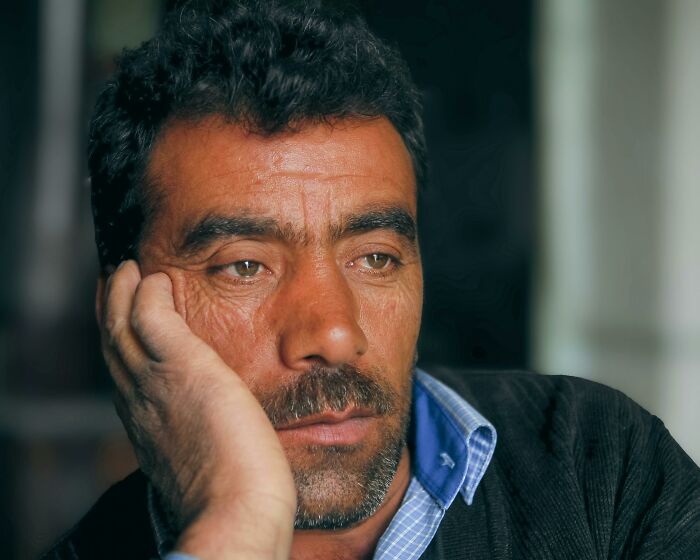 Middle-aged man with visible wrinkles and tired expression, showing body changes that indicate aging signs clearly.