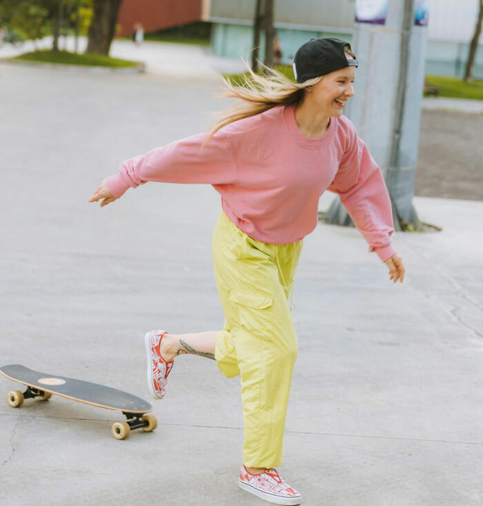 Young Gen Z person skating outdoors, wearing casual colorful clothes, illustrating middle class challenges and lifestyle changes.