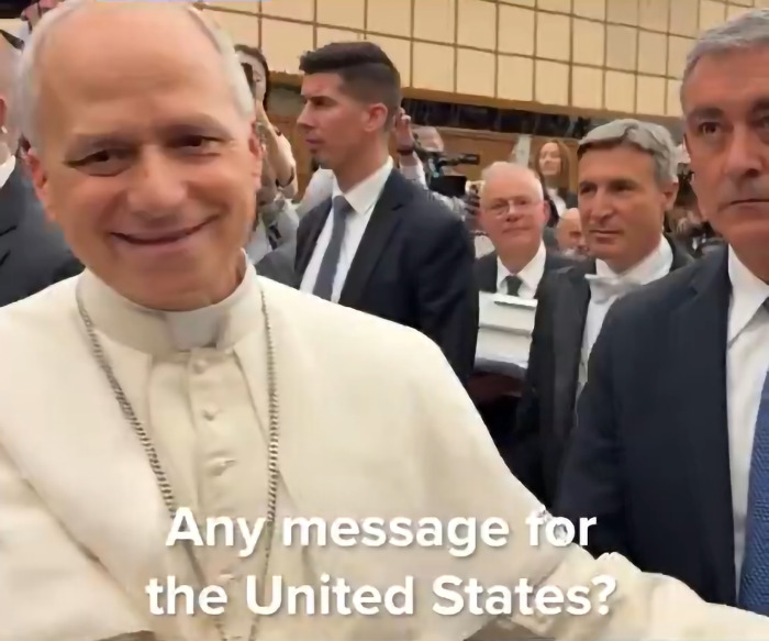 The Pope smiling and interacting with a crowd while delivering a menacing message to the United States.