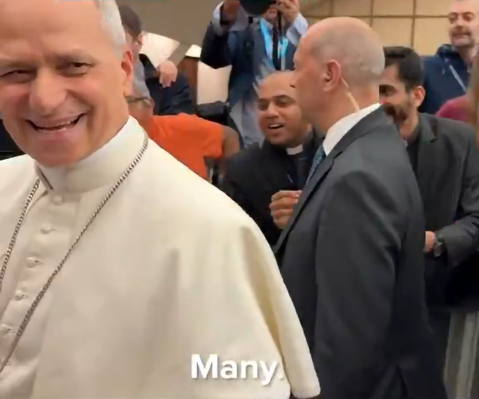 The Pope smiling and interacting with a group of people, sharing a menacing message about the United States.