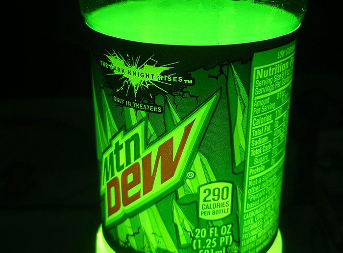 Glowing Mountain Dew bottle design with The Dark Knight Rises branding, illustrating a notable corporate and PR disaster.