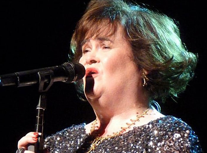 Woman singing on stage with microphone, representing a notable moment in corporate and PR disasters history.