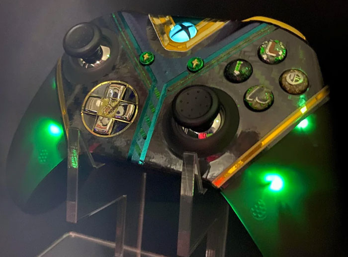 Customized Xbox controller with green LED lights, symbolizing technology in corporate and PR disaster stories.