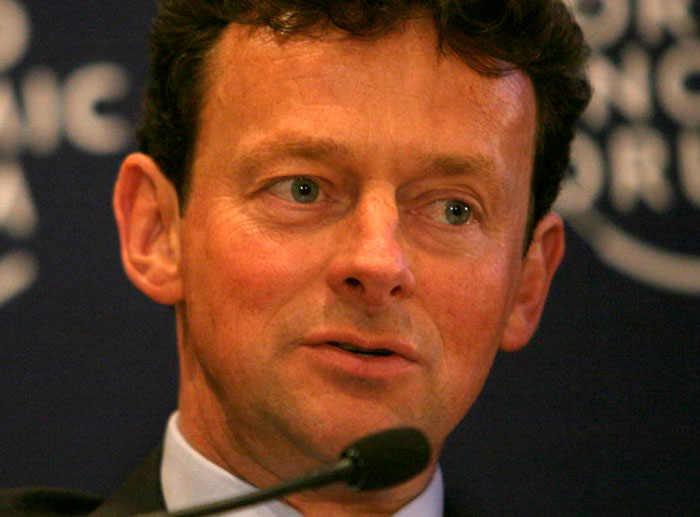 Businessman speaking at a conference microphone representing corporate and PR disasters in history.