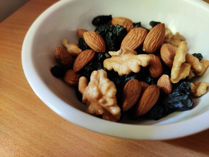 Bowl of mixed nuts and dried fruits illustrating common foods that go bad more quickly than expected.