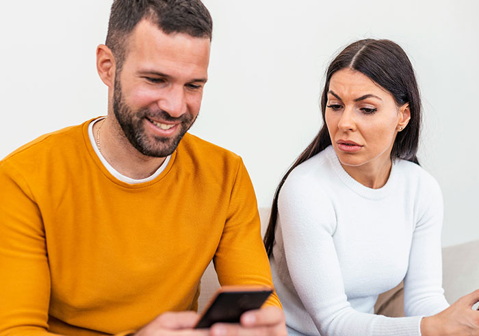 Man gaslights wife during tense moment, wife looks upset and regretful, capturing relationship struggle and emotional conflict.