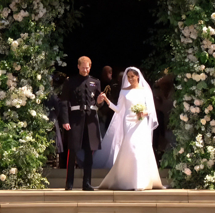 Meghan Markle and Prince Harry walking down steps after wedding, Meghan Markle gets slammed in anniversary post controversy