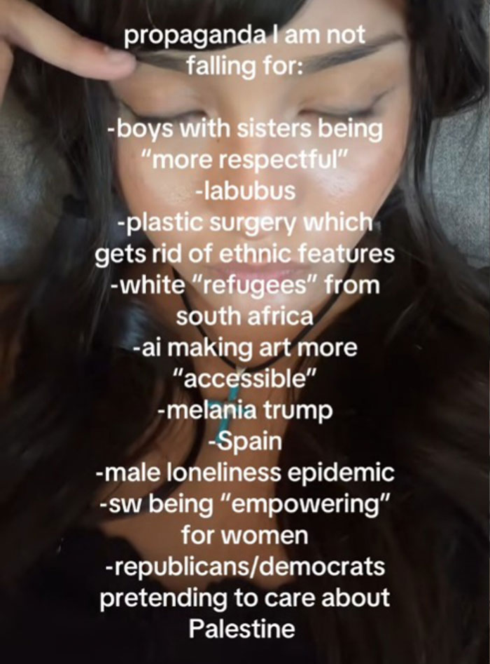 Person pointing to forehead with text listing propaganda topics they refuse to fall for including ethnic features and AI art accessibility.