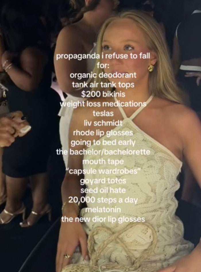 Young woman in a cream dress at an event with text listing types of propaganda she refuses to fall for.