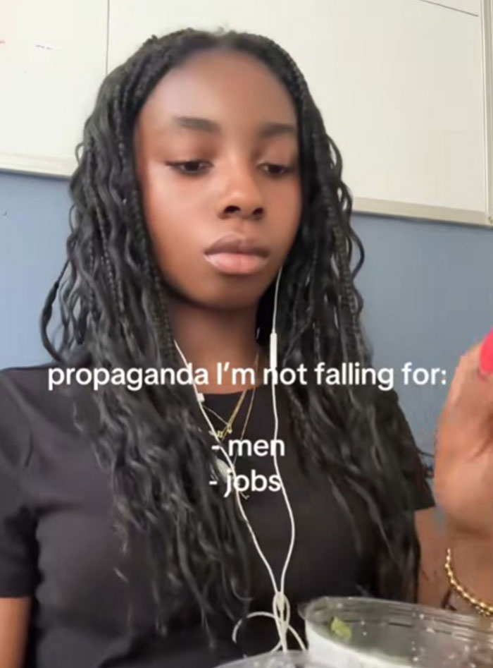 Young woman wearing headphones, sharing types of propaganda she refuses to fall for, including men and jobs.