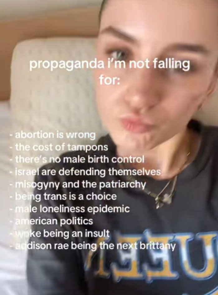 A woman in a dark shirt sharing a list of propaganda topics she refuses to fall for, including abortion and misogyny.