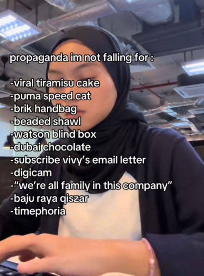 Woman in a hijab listing various online propaganda trends she refuses to fall for in a casual office setting.
