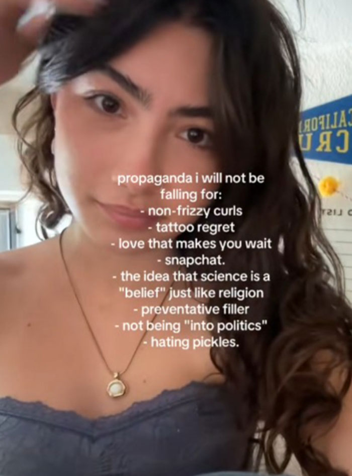 Young woman with curly hair sharing a list of propaganda she refuses to fall for, focusing on common misconceptions.