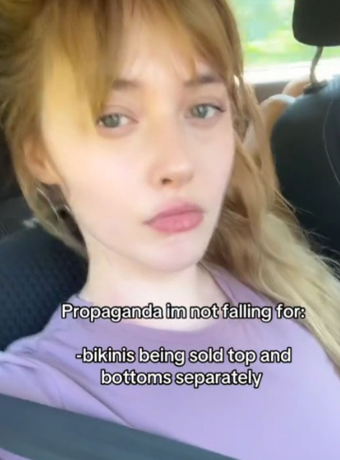 Young woman in car sharing her view on propaganda, refusing to fall for bikinis sold as separate tops and bottoms.