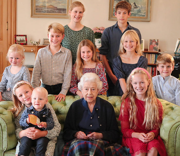 Group portrait with children and an elderly woman, highlighting right hand belongs to a male in the image editing context.