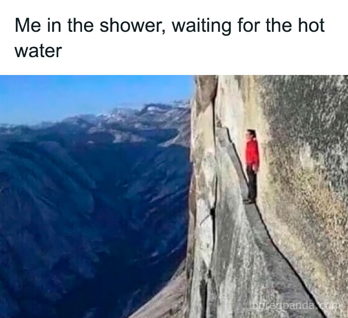 Person in red jacket standing on narrow cliff edge overlooking mountains, humorous Gen-Z memes concept.