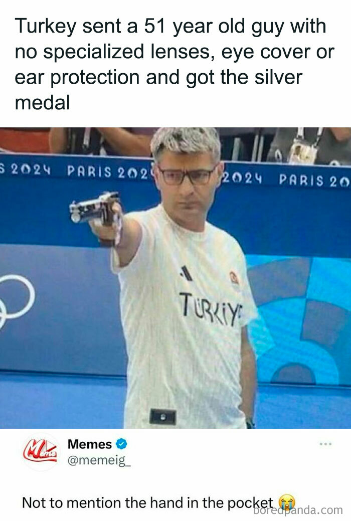 Man in Turkey shirt aiming a pistol with hand in pocket, illustrating funny posts about barely holding it together moments.