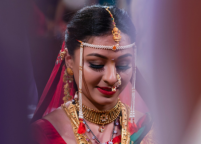 Bride adorned in traditional jewelry and attire, capturing a moment reflecting complex parent and child relationships.