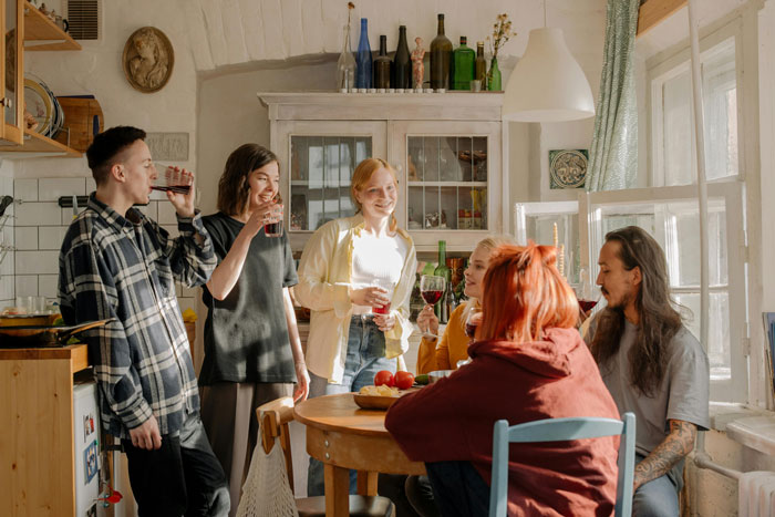 Group of students enjoying a house party while one student wonders if guests&rsquo; comfort justifies being asked to leave.