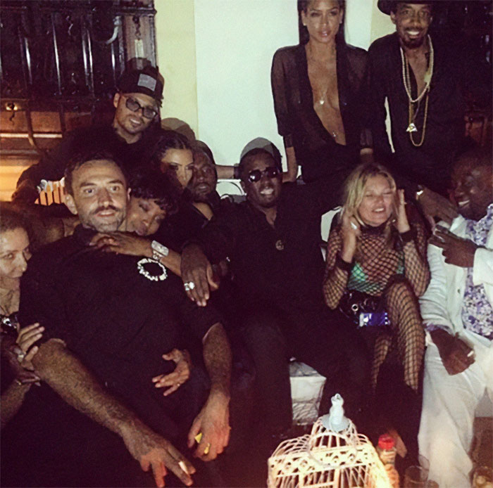 Group of people at a wild star-studded party in Ibiza, captured in photos deleted by Diddy amid trial.