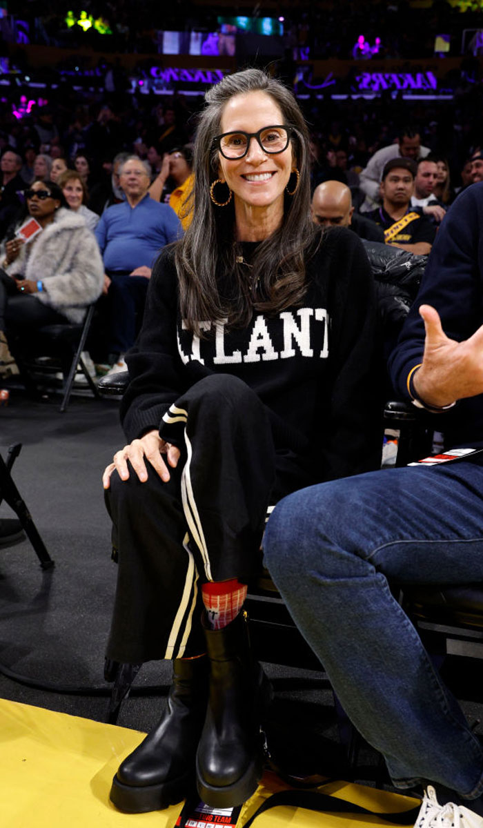 Jami Gertz wearing glasses and black Atlanta sweater at a public event, representing richest actor in the world 2025.
