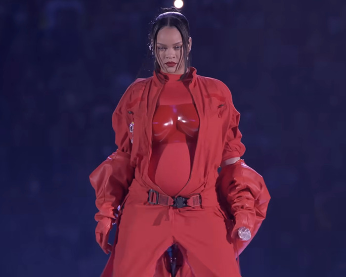 Rihanna showcasing her pregnancy in a bold red outfit during the 2025 Met Gala with A$AP Rocky.