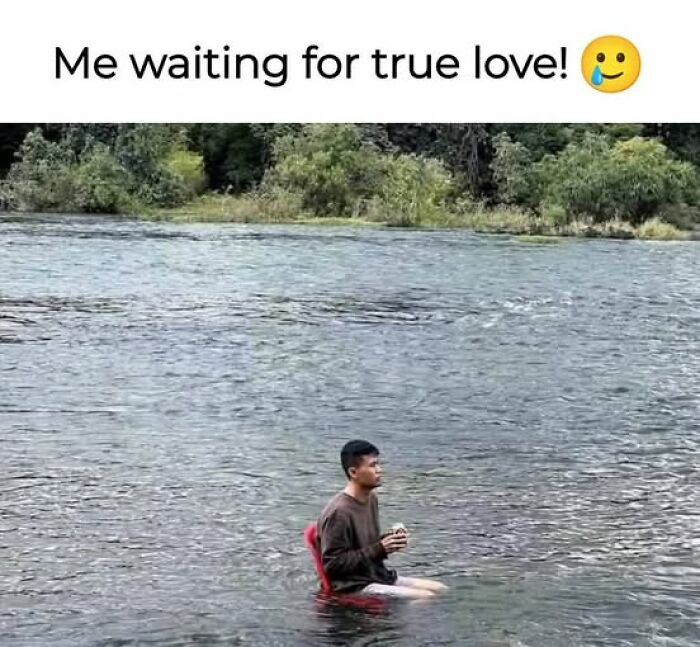 Man sitting on a chair in a river holding a sandwich, illustrating sarcastic memes about waiting for true love.