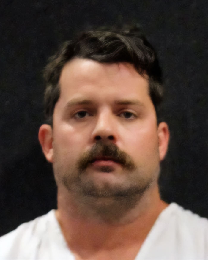 Man with mustache and short hair against dark background related to marriage revelation and hot car incident. Man with mustache and short hair against dark background related to marriage revelation and hot car incident.