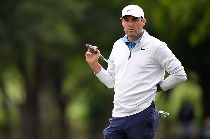 Scottie Scheffler on the golf course wearing white Nike top, demonstrating the financial power of golf&rsquo;s rising superstar.