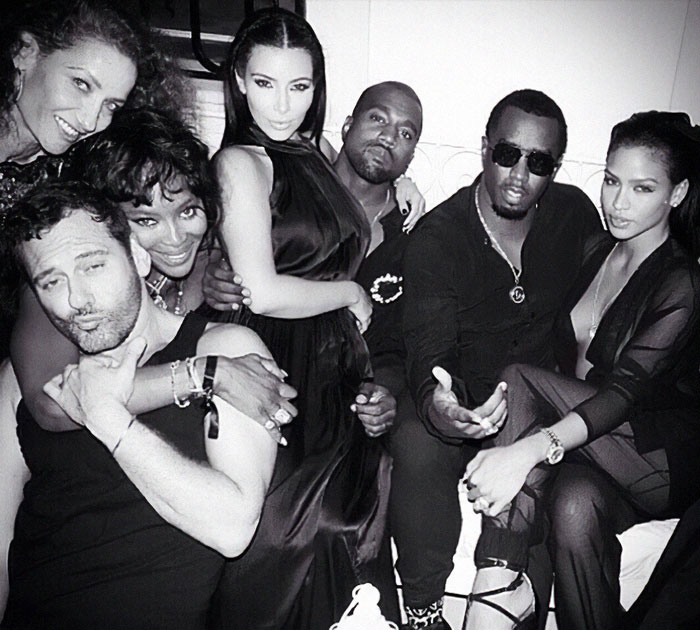 Star-studded party in Ibiza with celebrities including Diddy, posing closely in a lively, black-and-white photo.