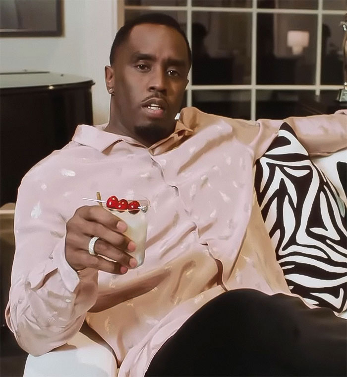 Diddy sitting on a couch holding a cocktail, related to the trial jury stunned by graphic photos from freak off parties. Diddy sitting on a couch holding a cocktail, related to the trial jury stunned by graphic photos from freak off parties.