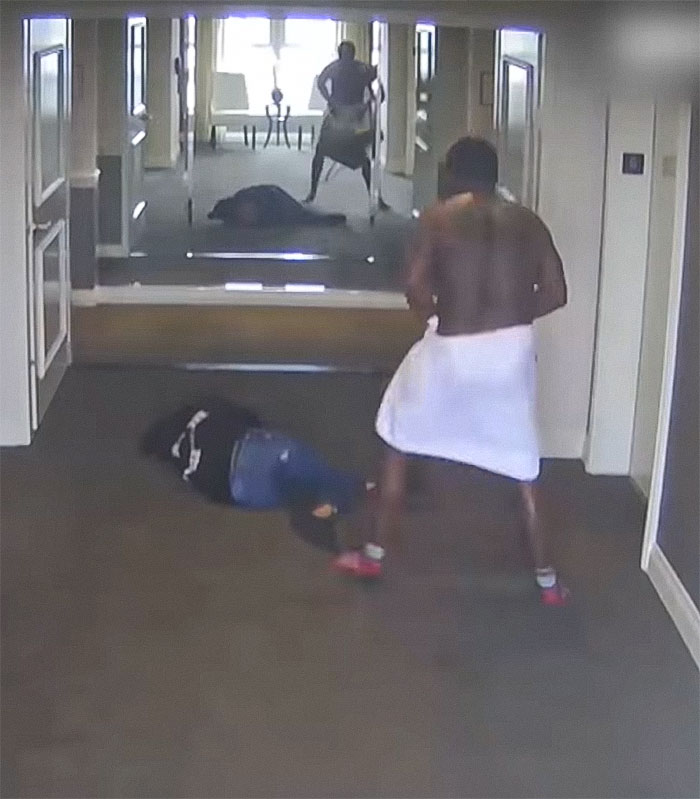 Surveillance image showing a shirtless man in towel and another person lying on the floor during Diddy trial graphic party photos. Surveillance image showing a shirtless man in towel and another person lying on the floor during Diddy trial graphic party photos.