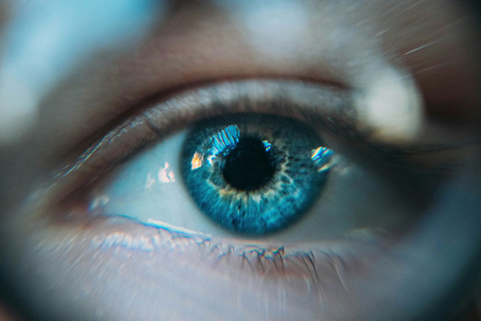 Close-up of a blue eye highlighting symptoms that can seem harmless but need immediate medical attention.