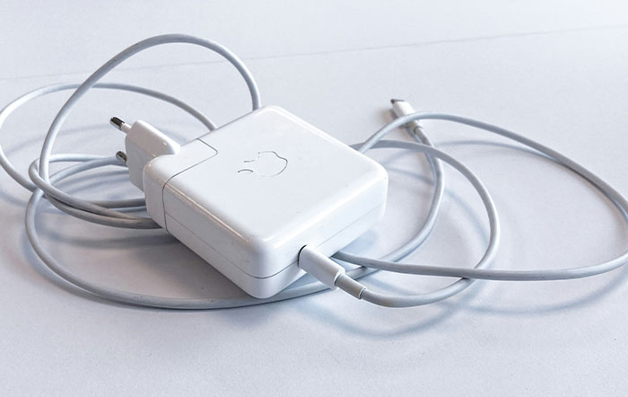 Apple charger with tangled cable on a white surface illustrating times people didn’t know how to handle simple tasks
