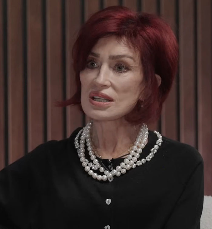 Sharon Osbourne with red hair and pearl necklace in a black top, discussing Ozempic and weight management during an interview. Sharon Osbourne with red hair and pearl necklace in a black top, discussing Ozempic and weight management during an interview.