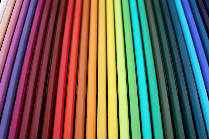 Close-up of colorful pencils arranged in a gradient, showcasing vibrant hues winning the genetic lottery of colors.