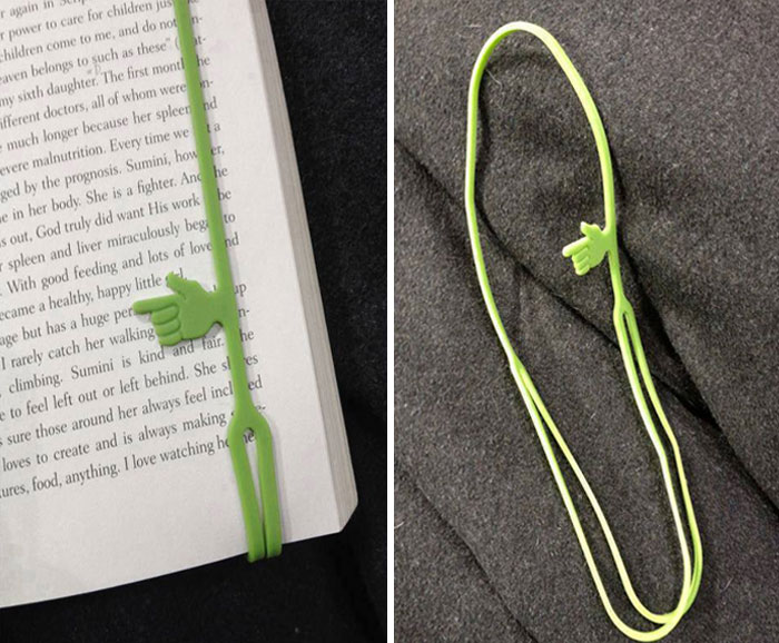 Green flexible bookmark with a hand-shaped pointer cleverly marking a page, showcasing creative solutions for overlooked issues.