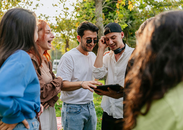 Group of young adults outdoors enjoying time together, highlighting things women stopped pretending they like after 30.